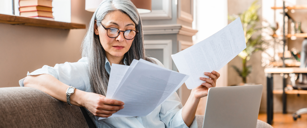 Image of a Person Looking at Some Papers Deciding Who Her Independent Trustee Is