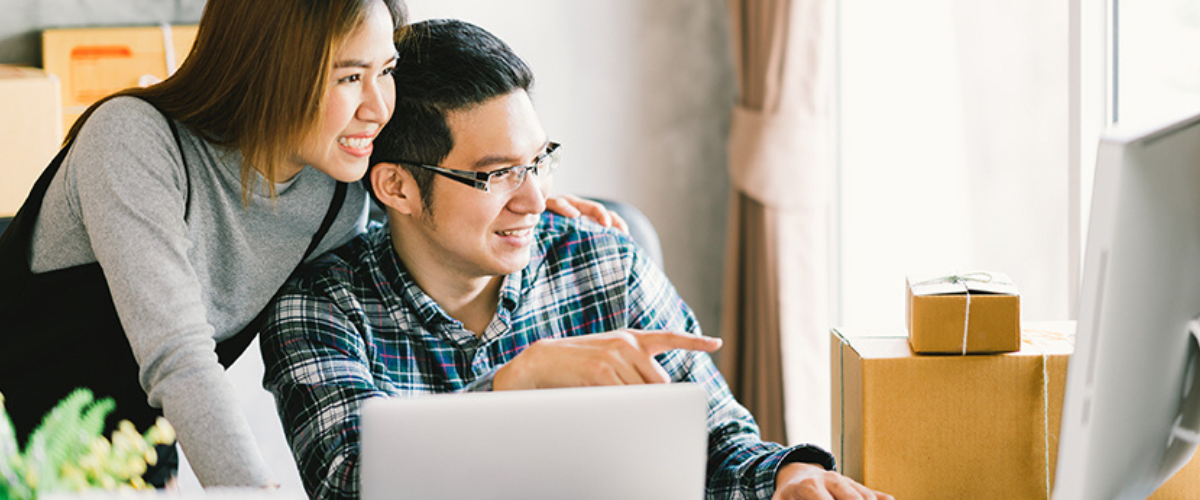 Small business owners reviewing their online marketing tools and digital business dashboard on a laptop screen.