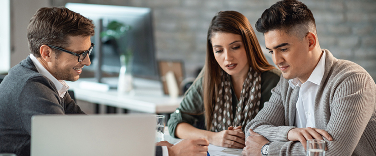 A small startup team discusses different types of business structures and advantages with a Northwest Bank advisor.