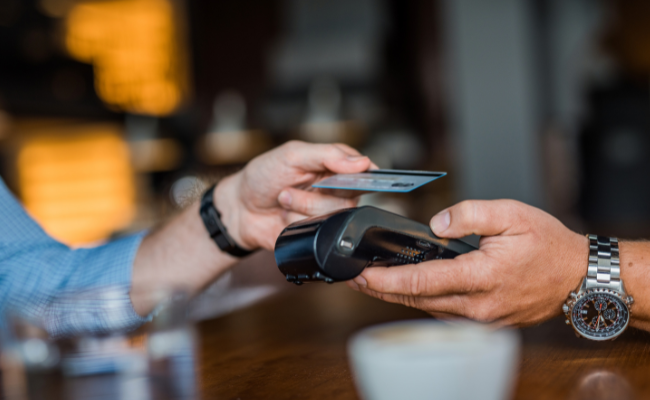 Image Of a Man Using His Northwest Bank Business Credit Card