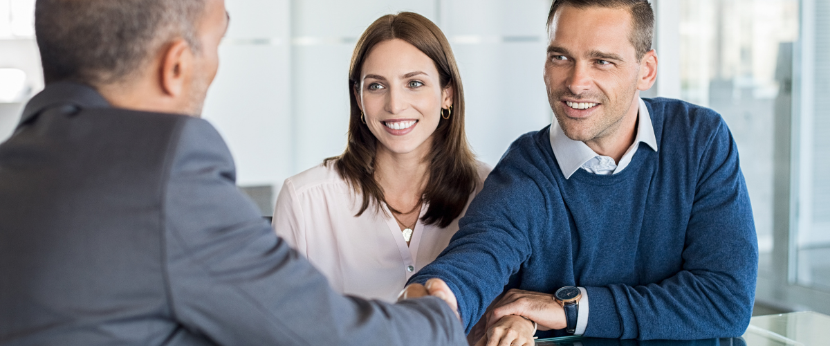 Image of couple discussing retirement planning with financial advisor