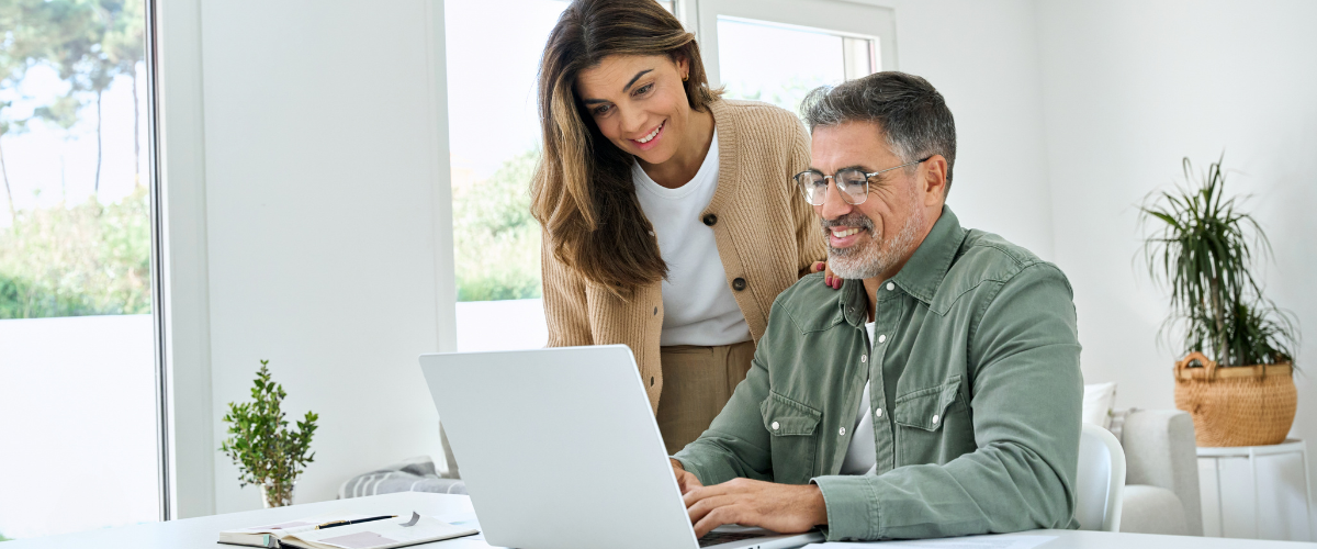 Image of a couple looking at their finances on computer