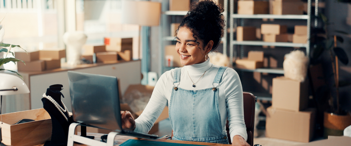 image of a small business owner on a computer searching for social media management tools.