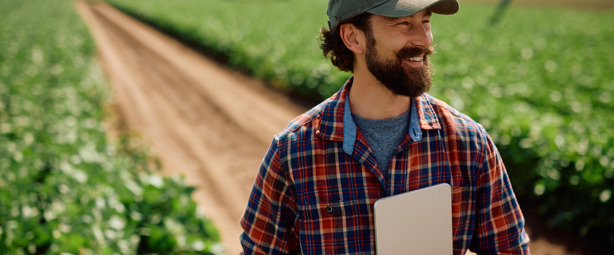 A male farmer using a tablet keeping his farm data safe online from cybersecurity threats