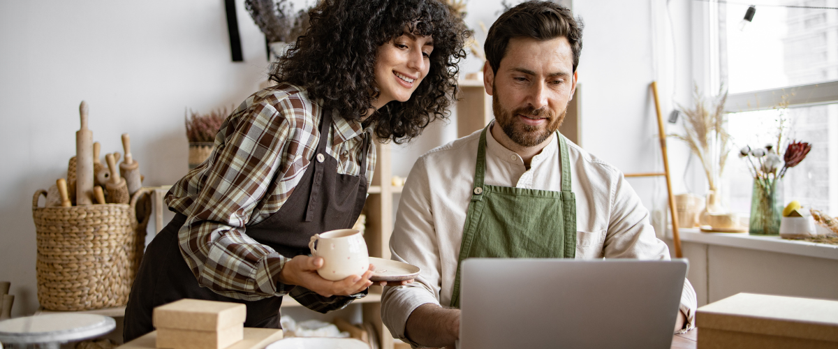 Image of Two small business owners using a computer to look into how to leverage SBA 7(a) loans for flexible partner buyouts.