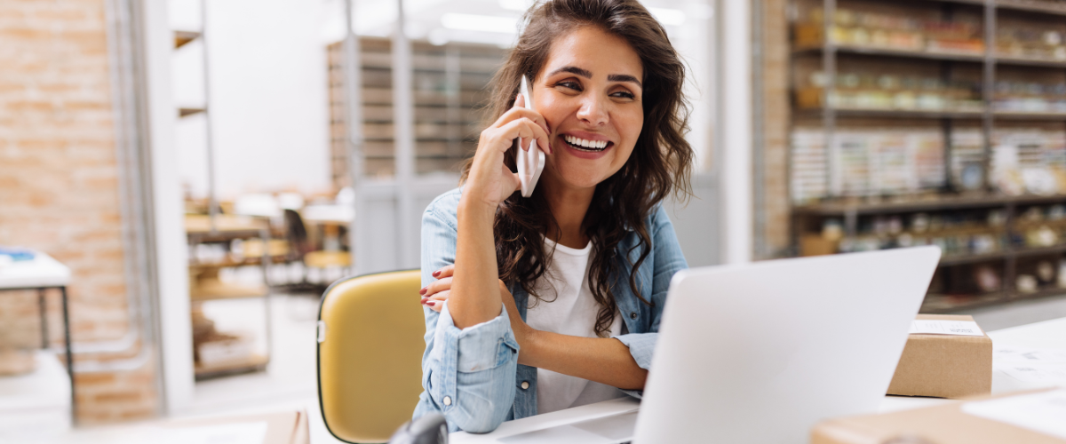 A Female Small Business Owner Talking With A Community Bank On How To Refinance Business Debt To Improve Cash Flow