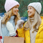 Image of a Mother and Daughter Holding their Northwest Bank Debit Cards Smiling Knowing they Ern Cash Back With Every Purchase!