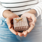 Image of someone holding a box containing a Northwest Bank gift Card