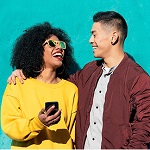 Man and women smiling and holding phone
