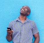 Man smiling and holding phone