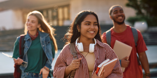 Image of three college students walking around campus