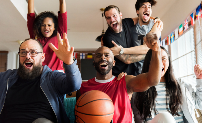Image Of March Madness Fans Watching Basketball Games From Home