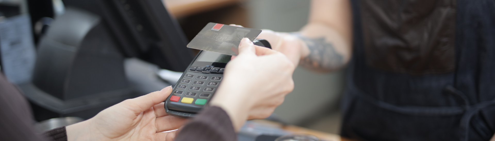Person Using Their Credit Card To Make Purchases