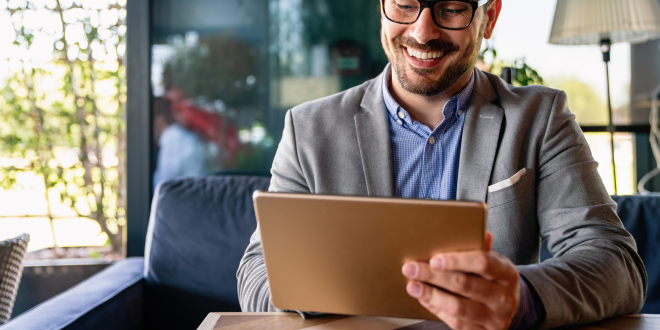 Man On HIs Laptop Exploring The Benefits of Private Banking