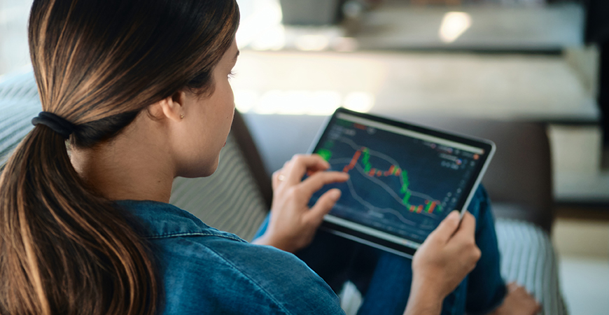 image of woman looking at stocks on tablet