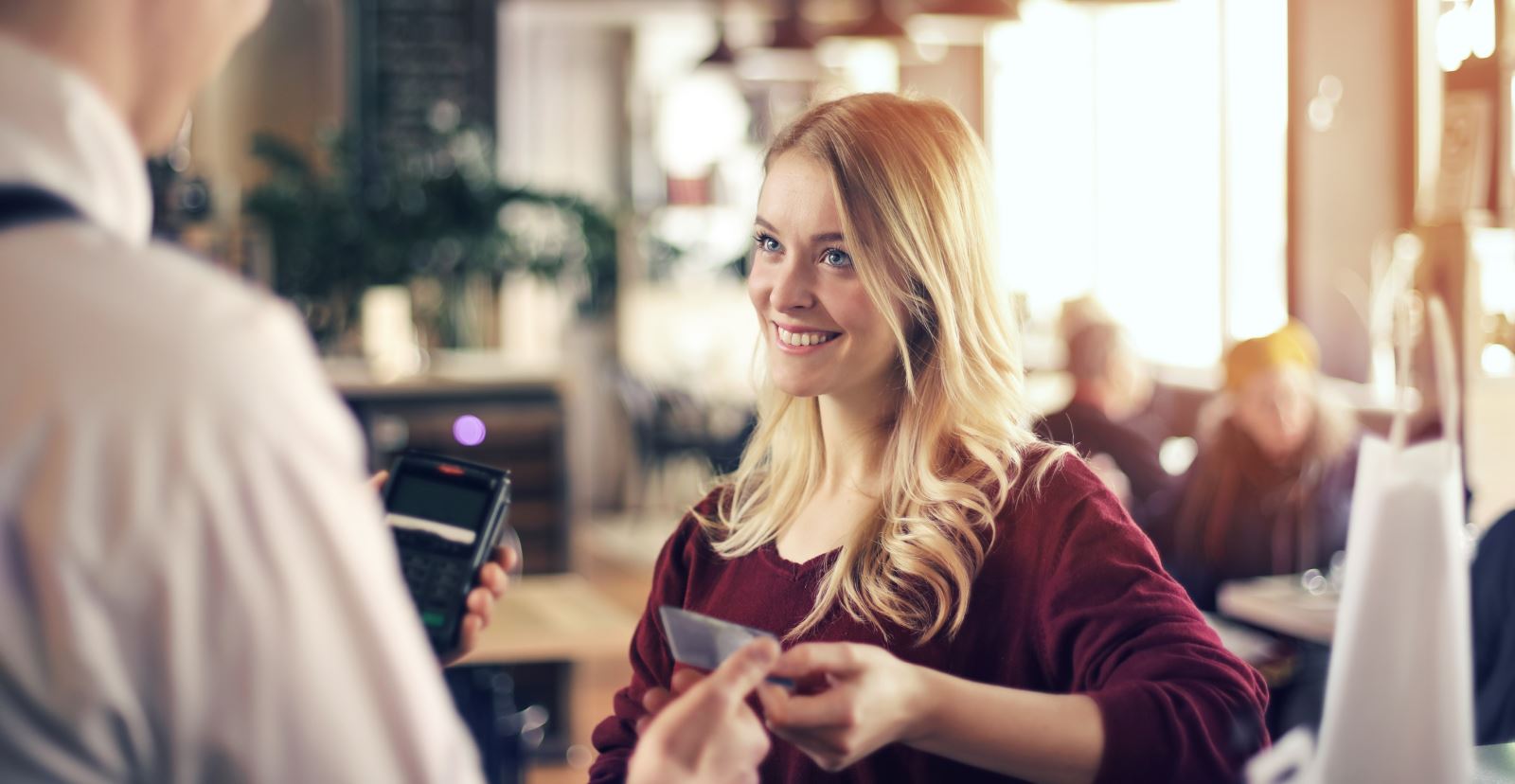 image of girl using debit card to purchase items