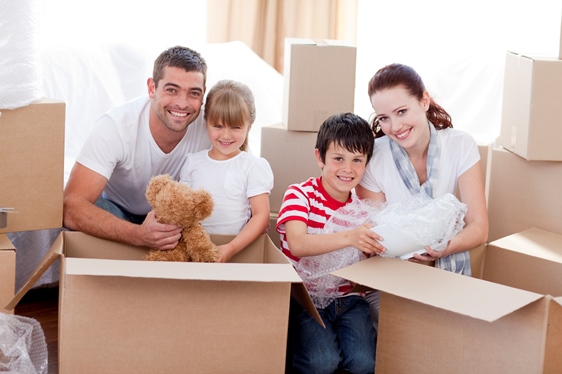 Image of a young family unpacking boxes